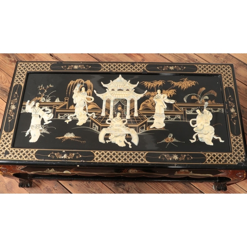 455 - A decorative glass topped coffee table featuring carved figures and feet along with a nest of two ta... 