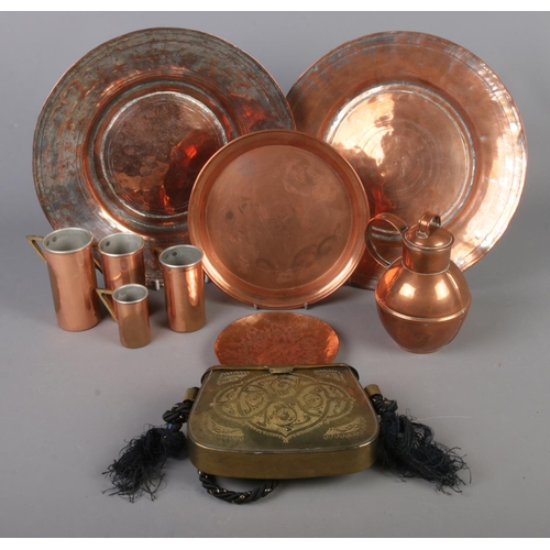 110 - A quantity of mostly copper. Including hammered plates, graduated cups, brass handbag, etc.