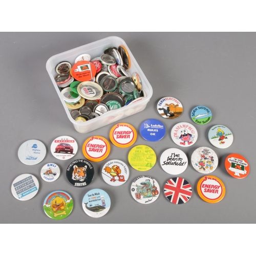 125 - A box of pin badges.