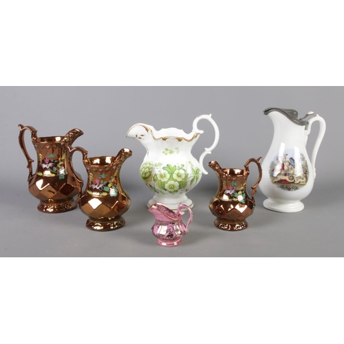 126 - A small quantity of handled jugs, including three graduated copper lustre and prattware examples.