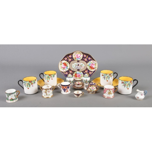 129 - A quantity of Crown Staffordshire miniature ceramics, to include cups and saucers, small centerpiece... 