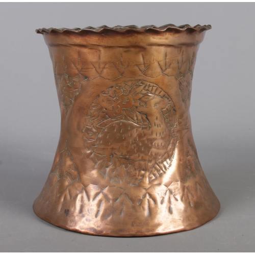 144 - A large hammered copper tankard with wavy edge and beaten decoration depicting deer and flowers. 17c... 