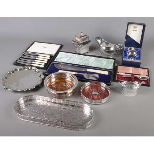 148 - A quantity of silver plate. Includes lion mask handle tea caddy, tray, wine bottle coasters, Mappin ... 