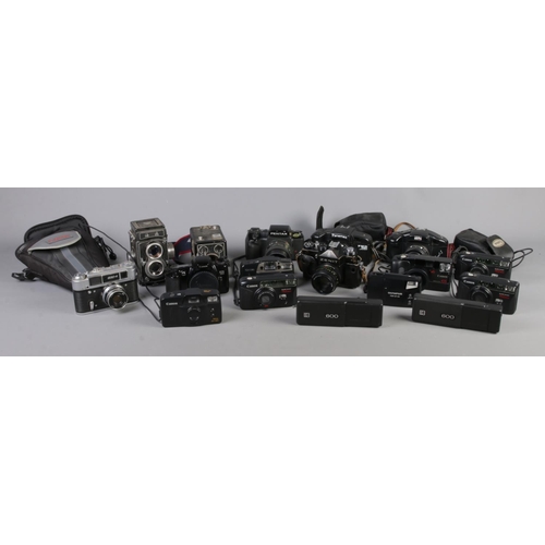 159 - A large quantity of assorted cameras, including Kodak Brownie, Pentax SF7, Zenit TIL and Akita Royal... 