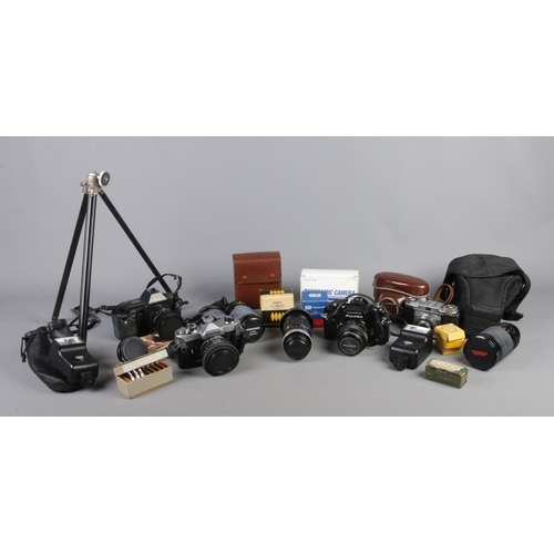 174 - A good collection of cameras and photographic equipment. To include Canon T70 and Zeiss Ikon cameras... 