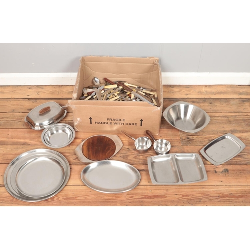 200 - A box of metalwares. Includes stainless steel trays, flatware, etc.