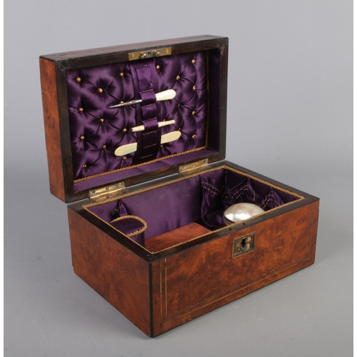 68 - A Victorian walnut hinged box and contents. To include leather pouch, mother of pearl egg and bone v... 