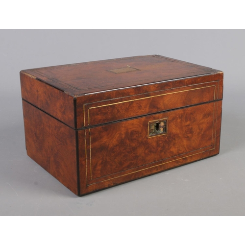 68 - A Victorian walnut hinged box and contents. To include leather pouch, mother of pearl egg and bone v... 