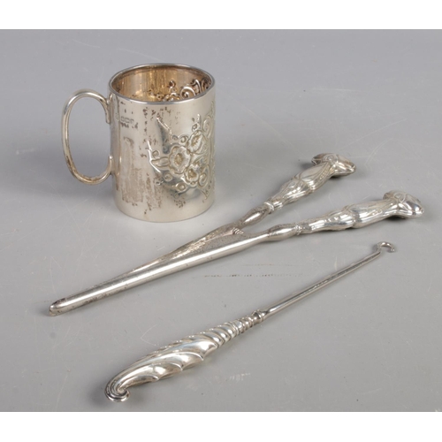 385 - A silver christening cup along with a pair of silver handled glove stretchers and button hook. Cup a... 