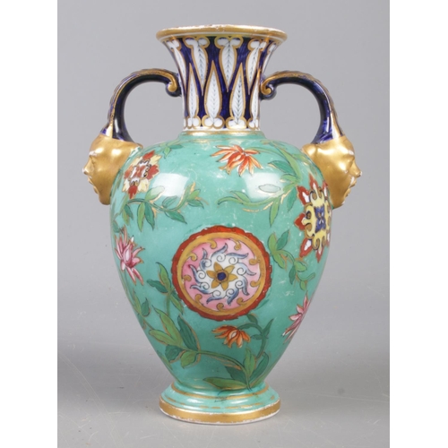 393 - A late nineteenth (C.1877-1890) century Derby twin mask handled urn vase,  on light blue ground with... 