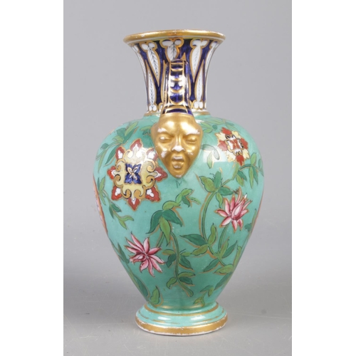 393 - A late nineteenth (C.1877-1890) century Derby twin mask handled urn vase,  on light blue ground with... 