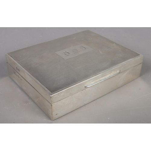 410 - A silver mounted cigarette box. Assayed Birmingham 1938 by Walker & Hall. Gross weight 231g.