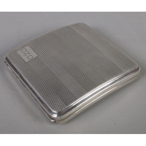 414 - A silver cigarette case. Assayed Birmingham 1929 by John Henry Wynn. 104g.