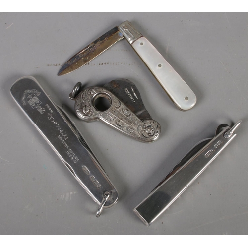 420 - A small quantity of silver. Includes silver handled cigar cutter, silver handle pocket knives, etc.