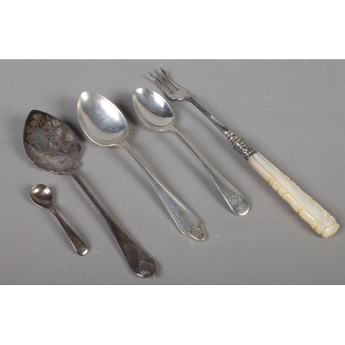 421 - A small quantity of silver. Includes silver spoons, silver pickle fork with mother of pearl handle, ... 