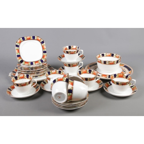 91 - A Roslyn bone china part tea set, in Imari colours. To include cups, saucers, sugar bowl and teapot ... 