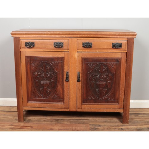 445 - A Victorian mahogany panelled sideboard, with carved detailing to the doors. Height: 94cm, Width: 11... 