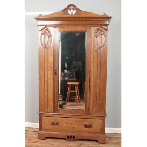 450 - A 20th century oak mirror front wardrobe.