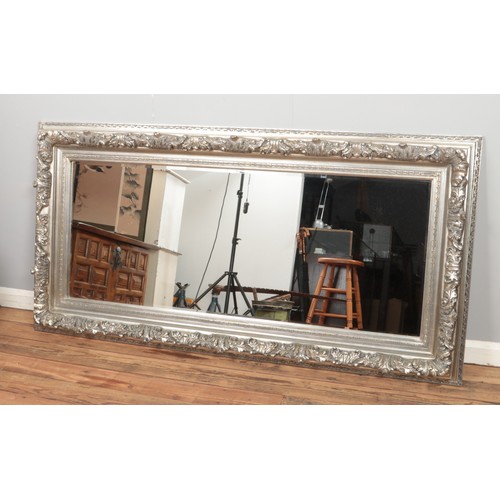 454 - A large modern bevel edge floor mirror featuring silver coloured floral frame. Approx. dimensions 94... 