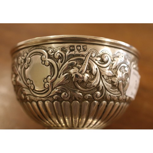 384 - A silver pedestal bowl with repousse decoration. Assayed London 1893 by Carrington & Co. 12cm diamet... 