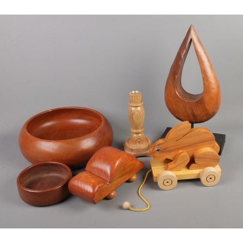 125 - A collection of carved wooden items including toy rabbit, bowl, teardrop sculpture, etc.