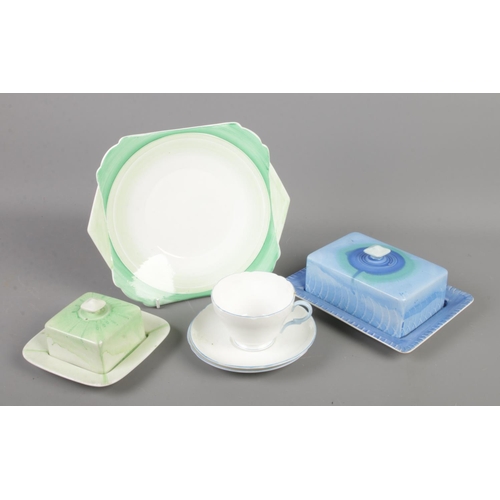 136 - A small collection of Shelley pottery and china. Includes two butter dishes, cup and two saucers and... 
