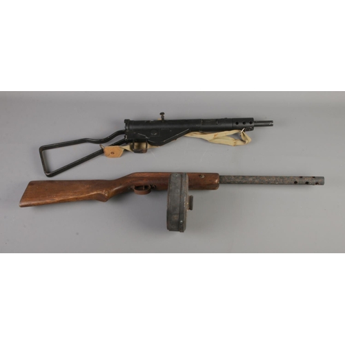 141 - A replica bolt action machine gun along with replica tommy gun featuring Thompson marked circular ma... 