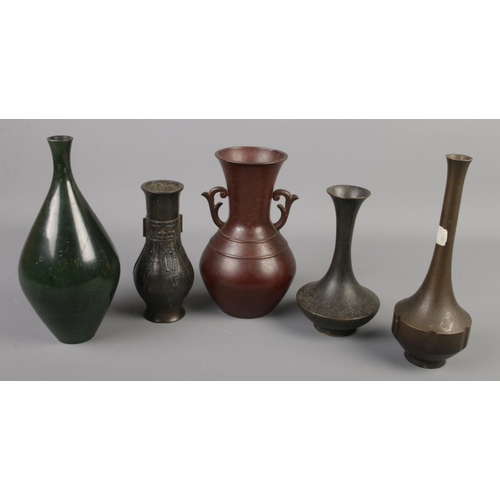 16 - Four Chinese bronze vases along with a similar enamel example.