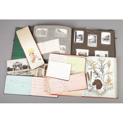 18 - A collection of ephemera. Includes postcards, scrap books, autograph books etc.