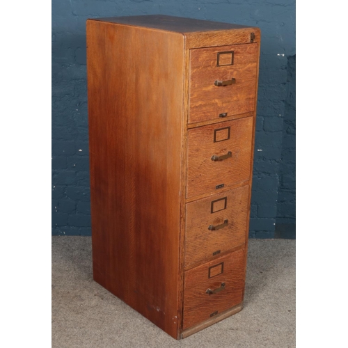 498 - A panelled oak four drawer filing cabinet. (131cm x 41cm x 67cm)