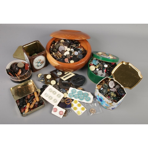 155 - A box containing a large quantity of vintage buttons, toggles and buckles.
