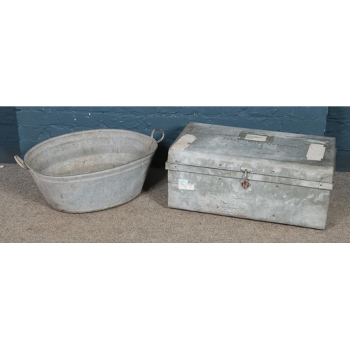 223 - A tin bath tub along with a tin trunk.