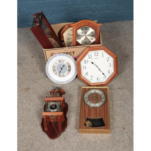 225 - A box of quartz wall clocks including Seiko, Abbey and Atlas examples.