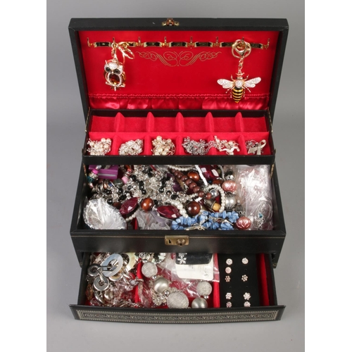 39 - A cantilever jewellery box, with contents of costume jewellery. To include necklaces, earrings and b... 