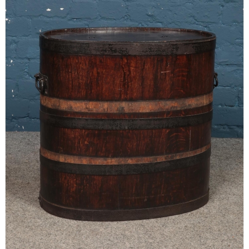 229 - A stained storage oak barrel featuring twin handles and removable lid. Approx. 54cm tall.