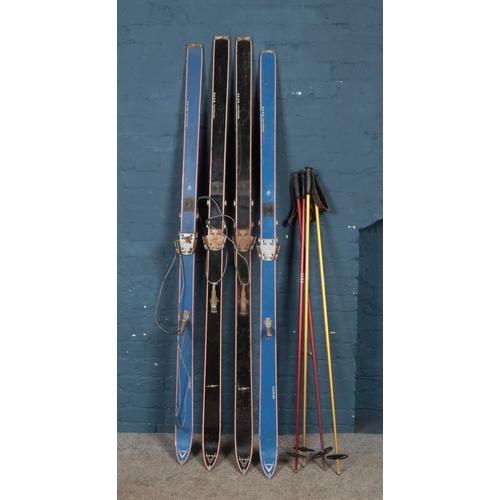 231 - Two pairs of Elan skis and poles.