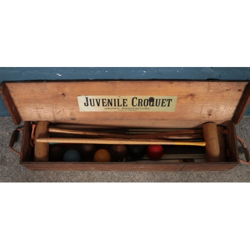 232 - A Juvenile Croquet set with seven balls and four mallets.