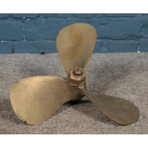 233 - A brass three blade propellor stamped COBI.