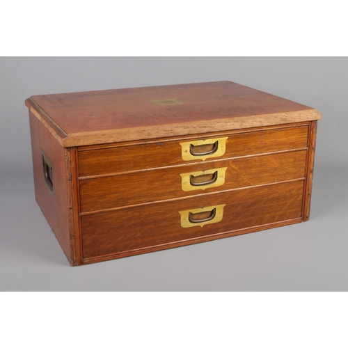 237 - An oak tabletop three drawer display cabinet featuring campaign handles to front and sides. Approx. ... 