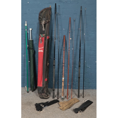 240 - A small quantity of fishing equipment. Includes two Omni Shakespeare rods, umbrella, rod rests, etc.