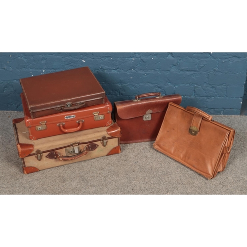 253 - A collection of leather suitcases and bags including Vanguard example.