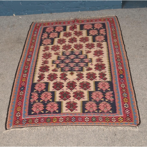 263 - A Senneh Kilim rug with fringe detailing. Approx. dimensions 148cm x 110cm.