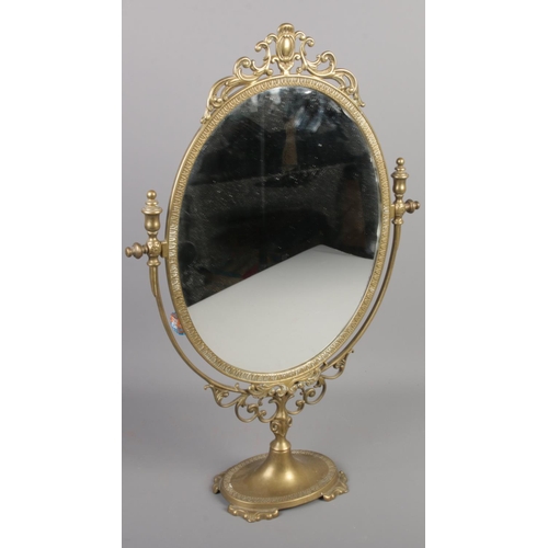43 - An ornate brass dressing table mirror.