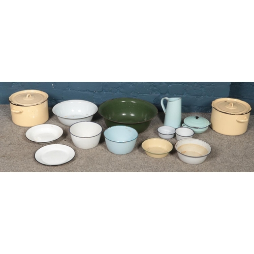 279 - A quantity of enamel kitchenalia. Includes bowls, jug, pots, etc.