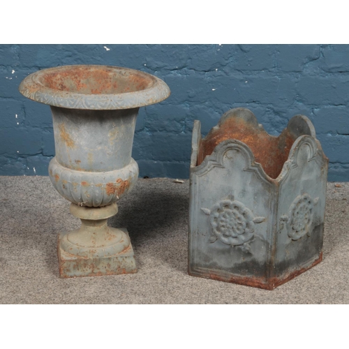 305 - Two metal garden planters, to include urn raised on square base and pentagonal sided example with Yo... 