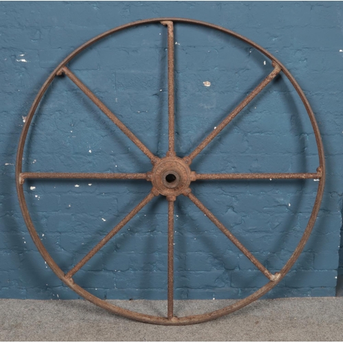 308 - A large cast iron cartwheel, stamped 'Wallace, Castle Douglas' Diameter: 124cm.