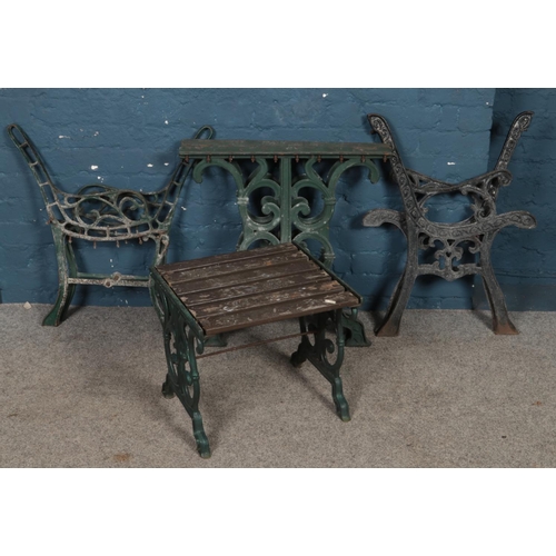 310 - Two pairs of cast iron bench ends along with a pair of cast iron table supports and a small garden t... 