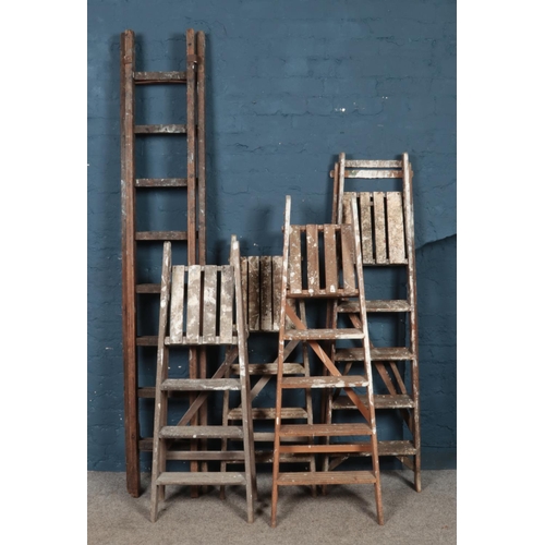 311 - Five sets of vintage wooden stepladders.