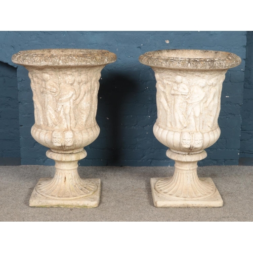 319 - A large pair of cast concrete Medici style garden urns, with classical decoration, on fluted socle b... 