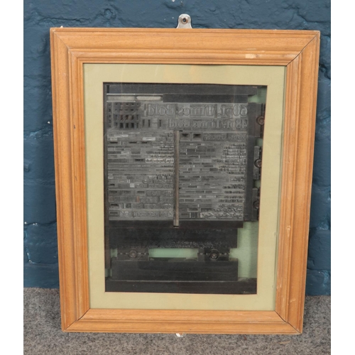 341 - A framed printing block display. (49cm x 39cm)